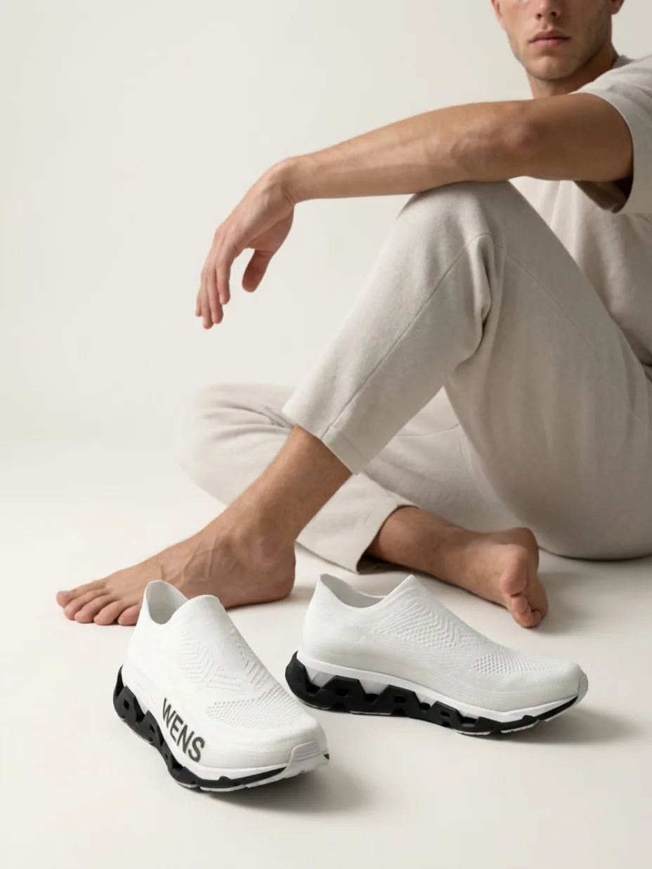 Footwear pair beside a model in an editorial scene