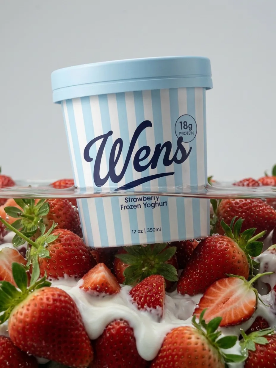 Yogurt packaging surrounded by strawberries
