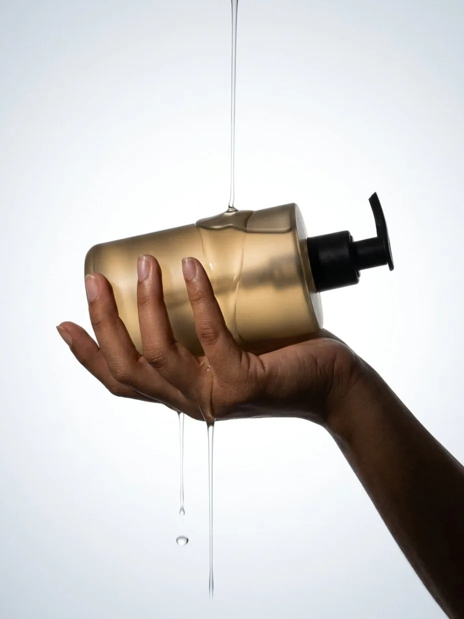 Beauty product held in backlight with a liquid accent